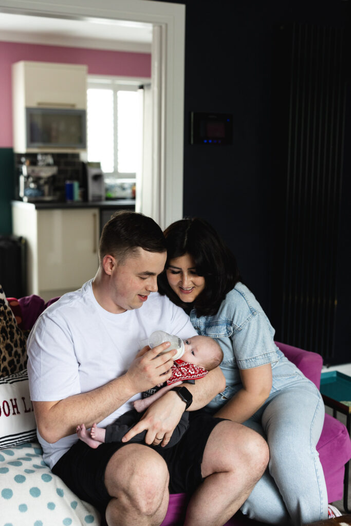 Quiet moment on the sofa with parents & their new baby