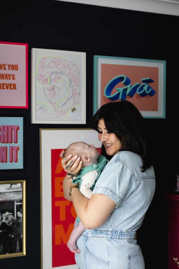 Mother holding her new baby in her home